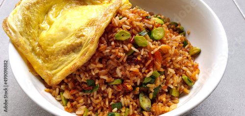 Traditional asian food fried rice with pete and omelette on top photo