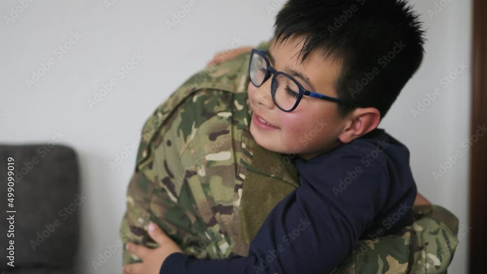 Military soldier embracing his son before leaving for the war Military soldier embracing his son before leaving for the war