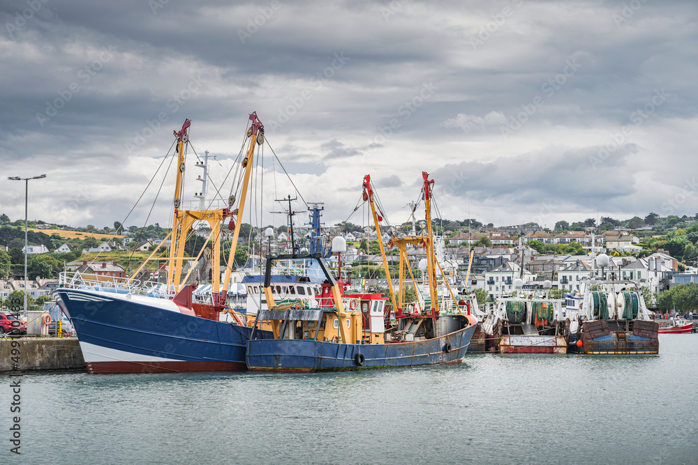 Large fishing boats moored in Howth harbour. Phishing and shellfish fishing equipment on fishing boats, Dublin, Ireland