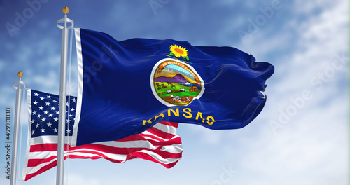 The Kansas state flag waving along with the national flag of the United States of America photo