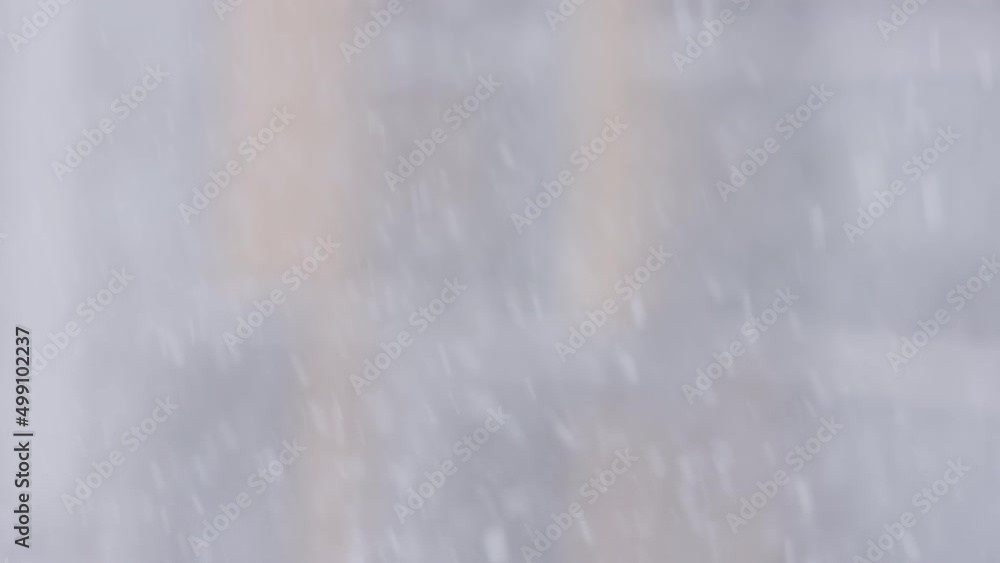 falling snow outdoors on building background. High quality 4k footage falling snow outdoors on building background. High quality 4k footage