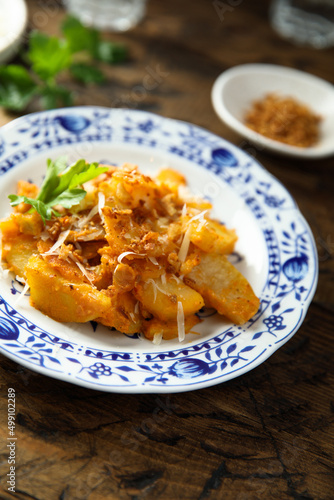 Roasted potato with red pesto and cheese