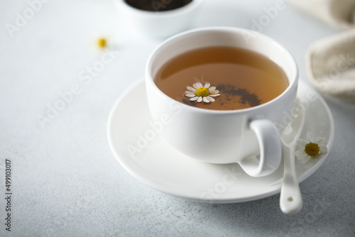 Healthy homemade chamomile tea in a white cup