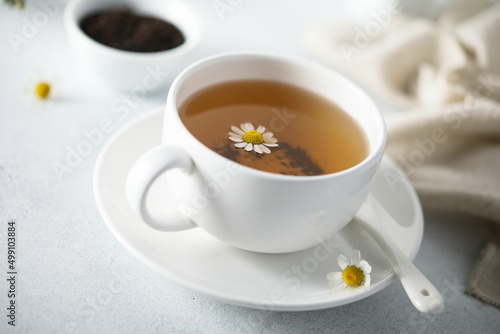 Healthy homemade chamomile tea in a white cup