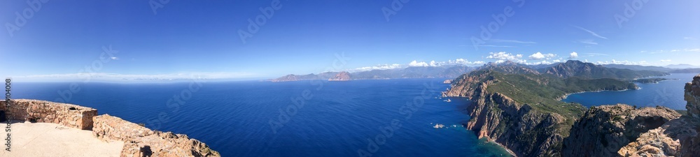 Panoramic view of the Corsica coast of the Mediterranean blue sea in summer