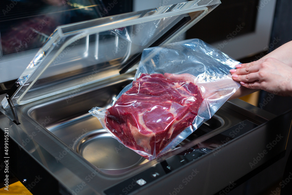vacuum cleaner and vacuum packaging of meat products StockFoto Adobe