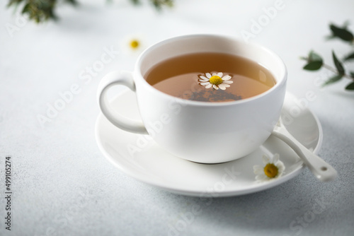 Healthy homemade chamomile tea in a white cup