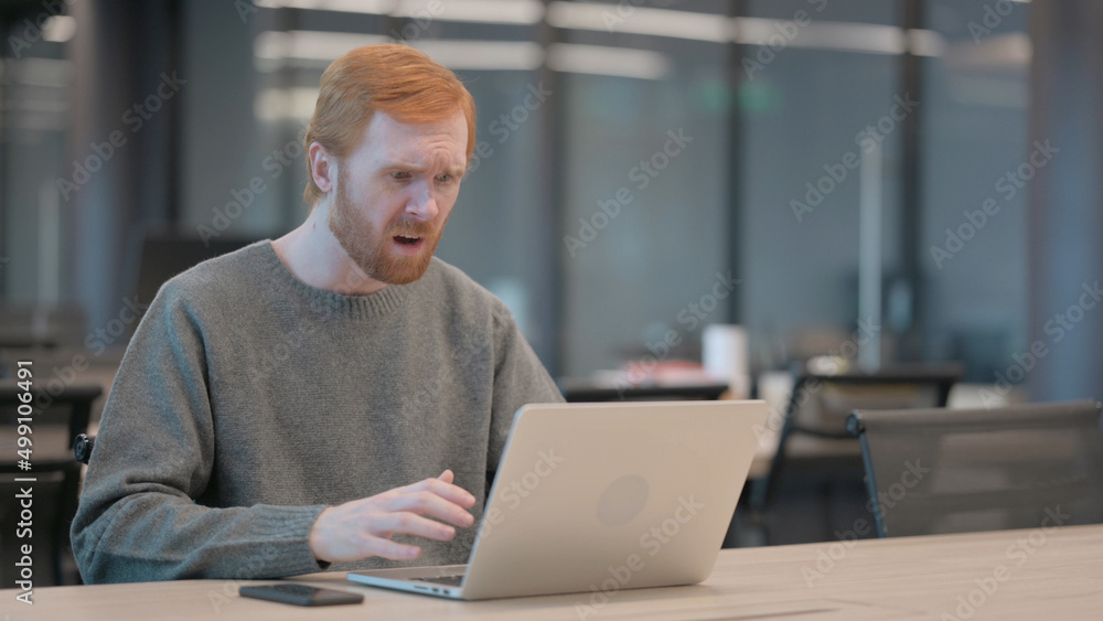 Young Man Reacting to Loss While using Laptop Young Man Reacting to Loss While using Laptop