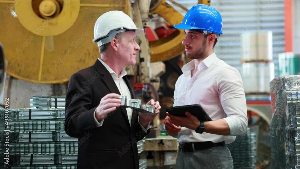 Caucasian business man and Factory engineer talking and discussion at Heavy Industry Manufacturing Factory. worker in safety hardhat at factory industrial facilities Caucasian business man and Factory engineer talking and discussion at Heavy Industry Manufacturing Factory. worker in safety hardhat at factory industrial facilities