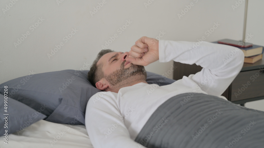 Man Coughing while Sleeping in Bed