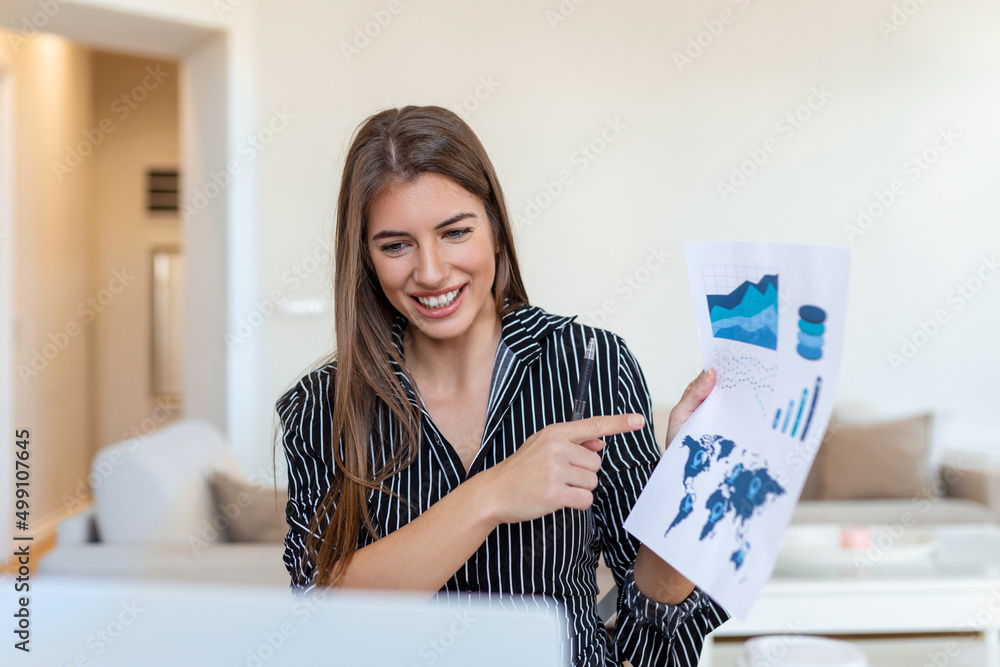 Focused business woman presenting charts and graphs on video call online. Young business woman having conference call with client on laptop. Young woman explaining how business work Focused business woman presenting charts and graphs on video call online. Young business woman having conference call with client on laptop. Young woman explaining how business work