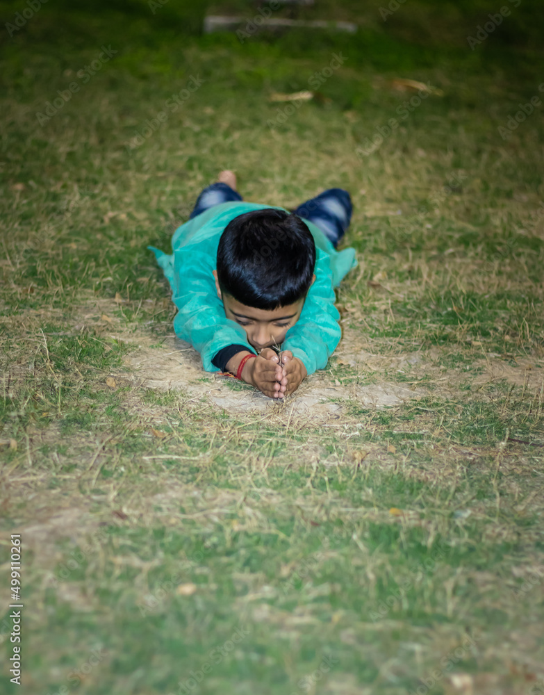 young kid meditating in traditional dress at evening from different angles young kid meditating in traditional dress at evening from different angles