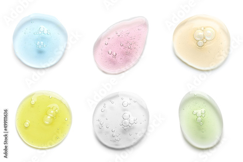 Foto Samples of different cosmetic serum isolated on white