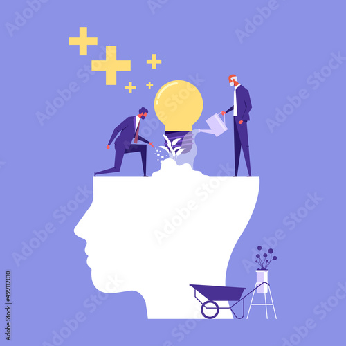 Businessman watering that growing lightbulb plant from the brain as metaphor growth personality. Personal growth-Self improvement and self development concept