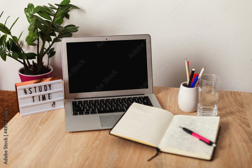 desktop with computer and notepad. study time is running out. lightbox with inscription study time. desktop with computer and notepad. study time is running out. lightbox with inscription study time.