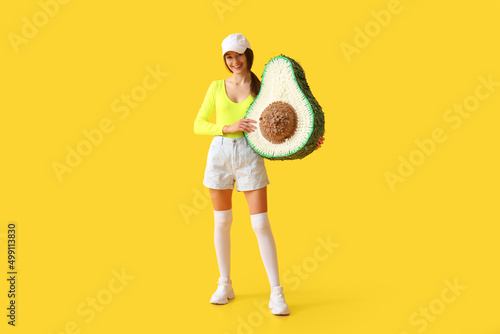 Smiling young woman holding...