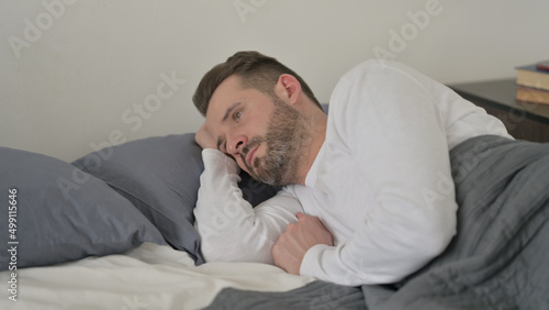 Man Awake in Bed Thinking