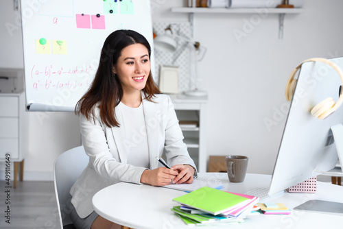 Young Asian tutor giving Ma...