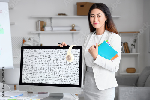 Young Asian tutor with copy...