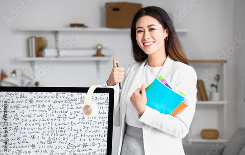 Young Asian tutor with copy...