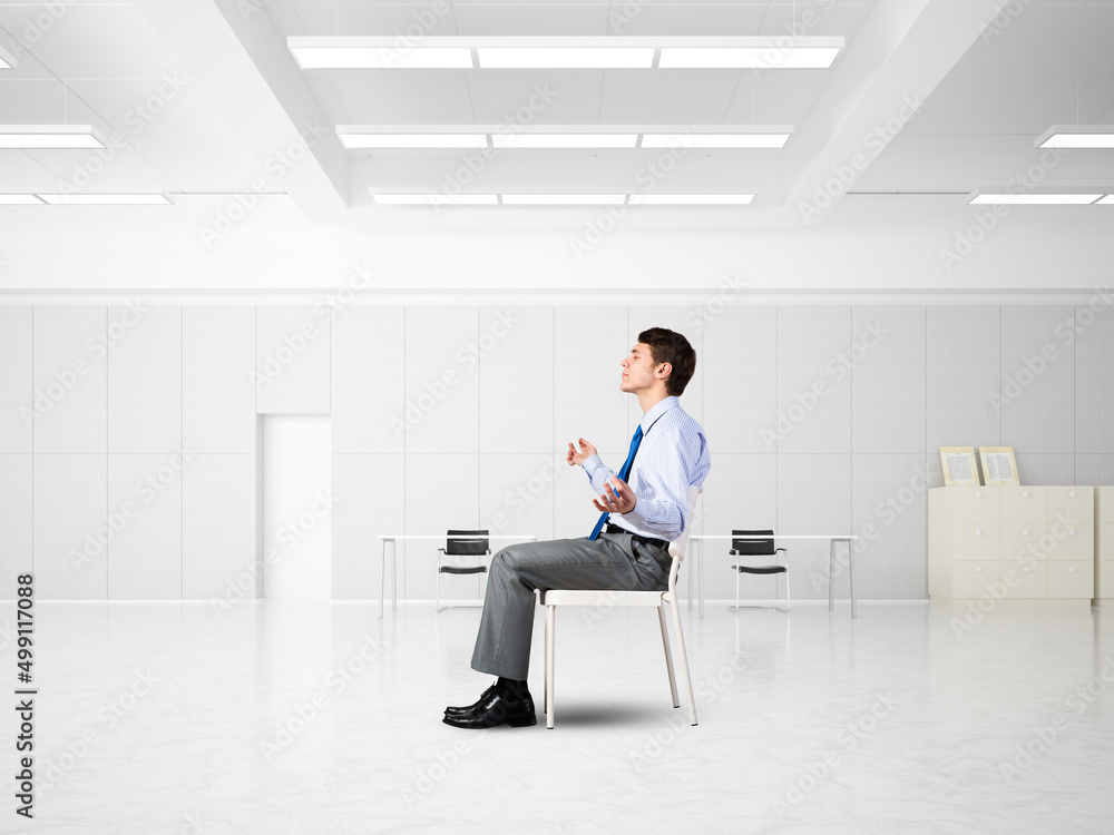 young businessman meditating in the office young businessman meditating in the office