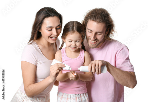 Parents applying tooth past...