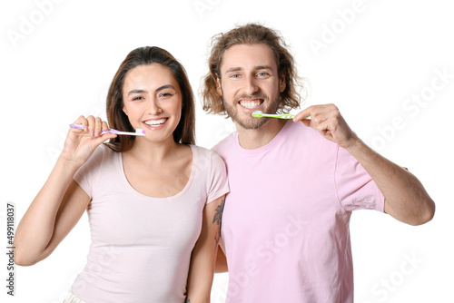 Happy young couple brushing...