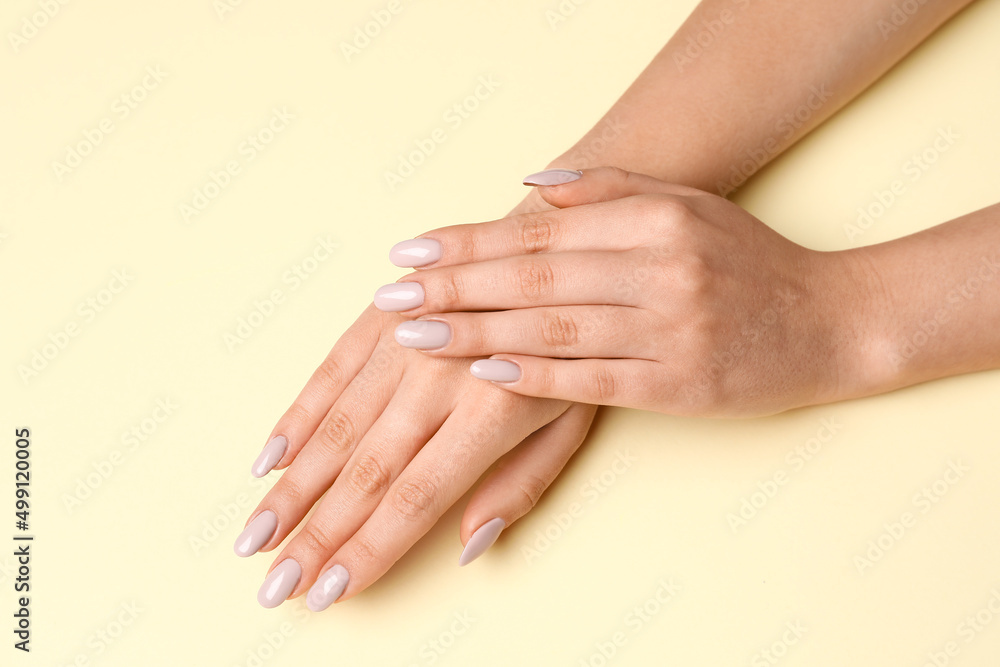 Female hands with beautiful manicure on yellow background Female hands with beautiful manicure on yellow background