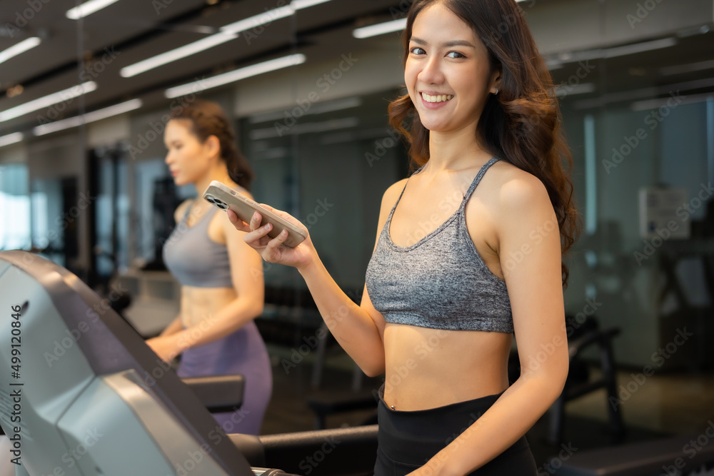 Young asian woman exercising on treadmill at a gym.Active people running on treadmill. smile and funny emotion. Young asian woman exercising on treadmill at a gym.Active people running on treadmill. smile and funny emotion.