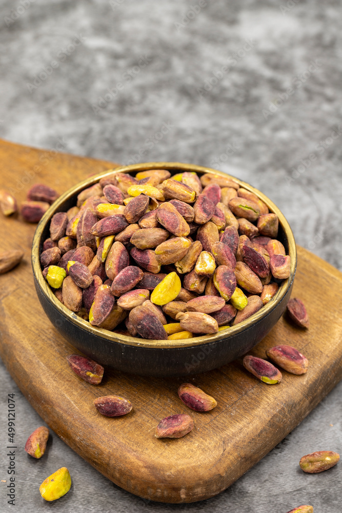 Pistachio kernel on dark background. A bowl of pistachios. close up Pistachio kernel on dark background. A bowl of pistachios. close up