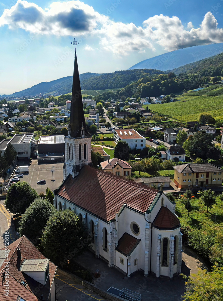 Panoramic view to St. Martin church. Village of Cressier, Switzerland. Year of construction - 1875