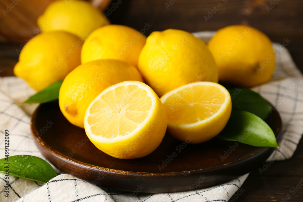Plate with ripe lemons on table Plate with ripe lemons on table