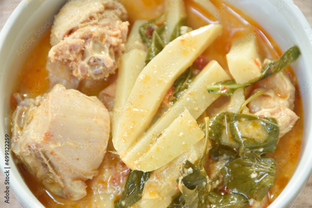 spicy boiled slice fresh bamboo shoot with chicken in coconut milk red curry soup on bowl spicy boiled slice fresh bamboo shoot with chicken in coconut milk red curry soup on bowl