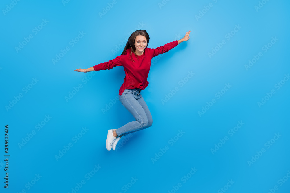 Full body photo of nice young lady jump wear eyewear shirt jeans footwear isolated on blue background