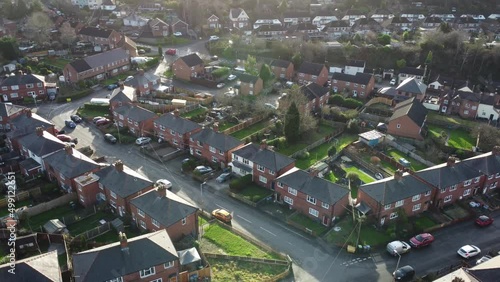 Generic view of a British street of houses with moving car