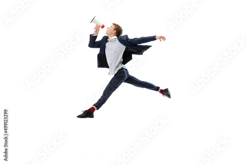 Man in office style clothes jumping and dancing isolated on white studio background. Business, start-up, open-space, inspiration concept.
