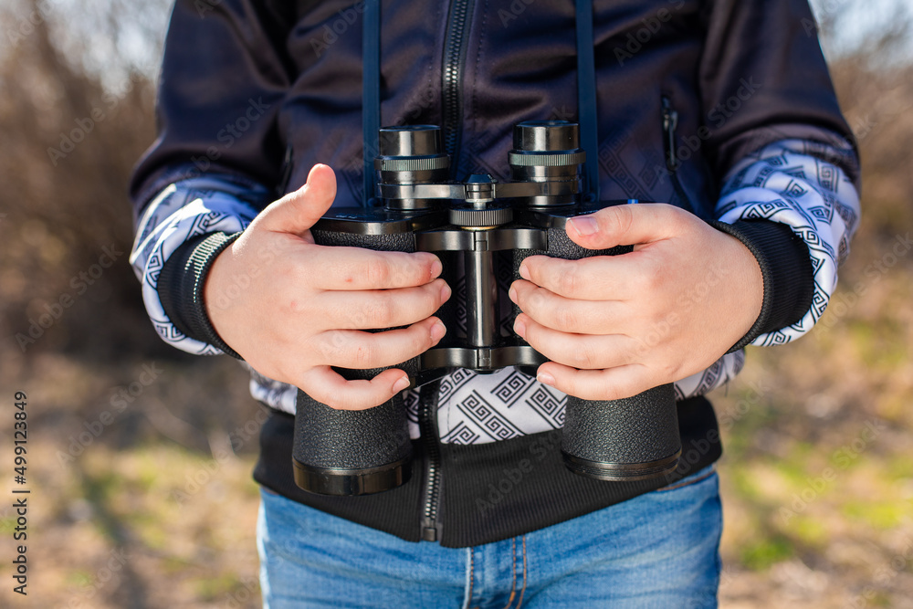 binoculars in the hands of a child binoculars in the hands of a child