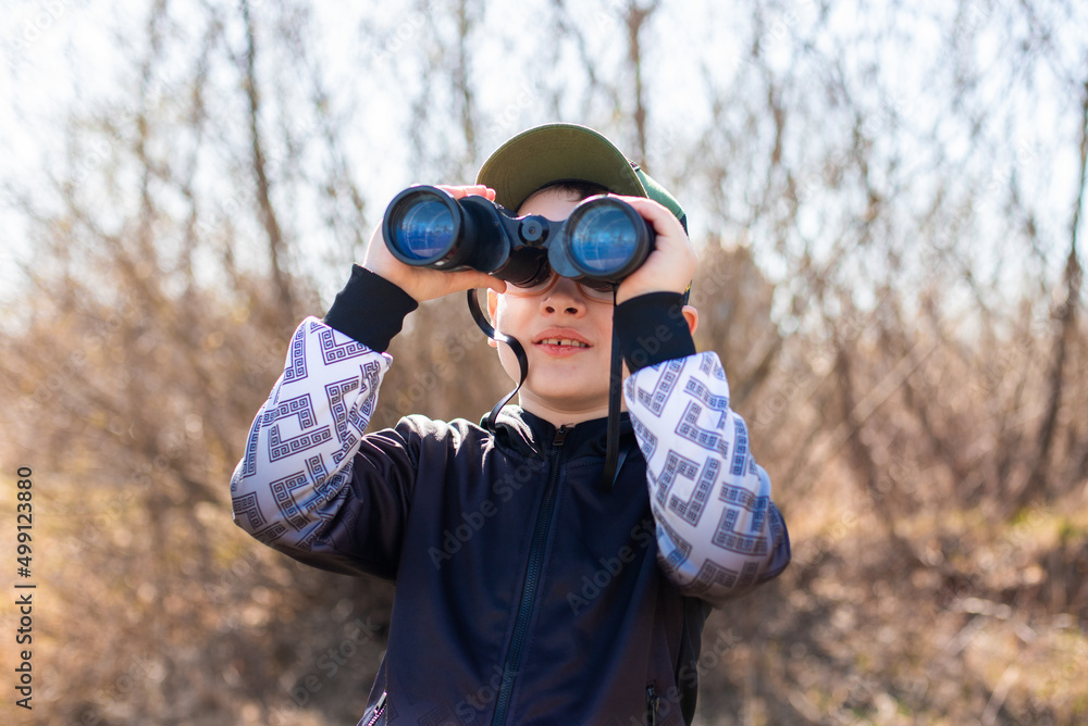 Child boy with binoculars in his hands Child boy with binoculars in his hands