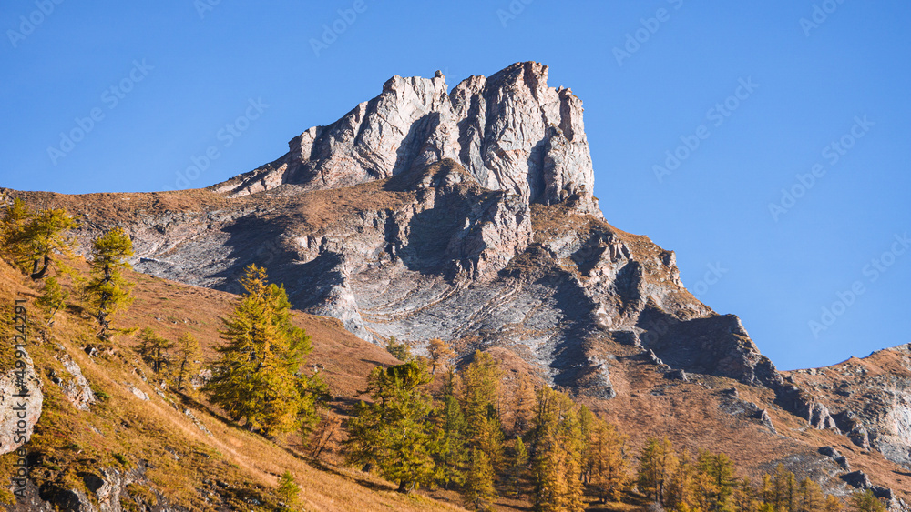 The mountains of the Lepontine Alps and the woods during a beautiful Autumn day, near the village of San Domenico di Varzo, Piedmont, Italy - October 2021.