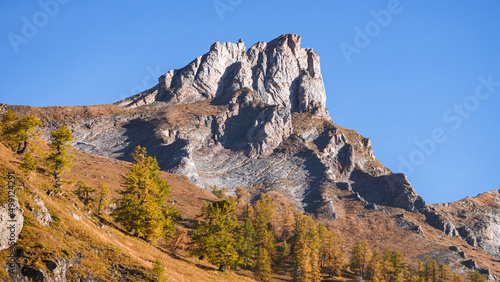 The mountains of the Lepontine Alps and the woods during a beautiful Autumn day, near the village of San Domenico di Varzo, Piedmont, Italy - October 2021. © Roberto