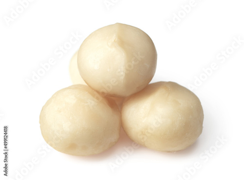 Unshelled macadamia nuts isolated on white background.