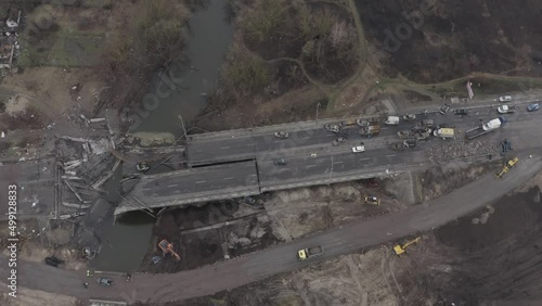 Abandoned cars near the destroyed bridge across the Irpin River. War in Ukraine. City of Irpin.
