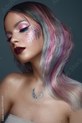 Beautiful girl with multi-colored hair and creative make up and hairstyle. Beauty face.
