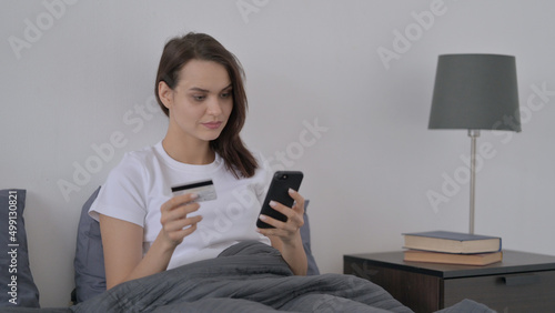 Woman Making Online Payment on Smartphone in Bed