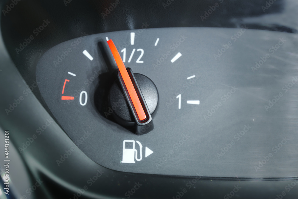 Naklejka premium Close up of a fuel gauge in a car, fossil gasoline consumption.
