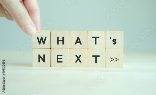 Fototapeta Naklejka Na Ścianę i Meble -  What's next?, business concept. Next step of work, plan, strategies, vision, project implementation, new opportunities and execution.  Putting wooden cubes with What's next?  and forward arrow symbols