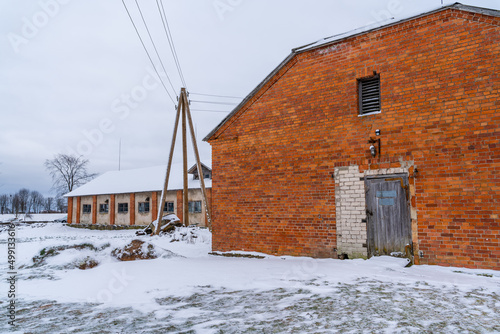 Power Line Pole next to Orange Brick Wall Old Farmhouse