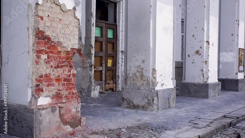 Damaged ruined civilian building in ukrainian city Chernihiv near Kyiv on north of Ukraine. Ruins during War of Russia against Ukraine in 2022. Walls, broken windows of buildings. Aircraft, artillery photo