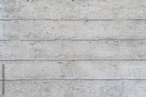texture of new gray grunge concrete wall with embedded grain and pattern of wooden planks for background