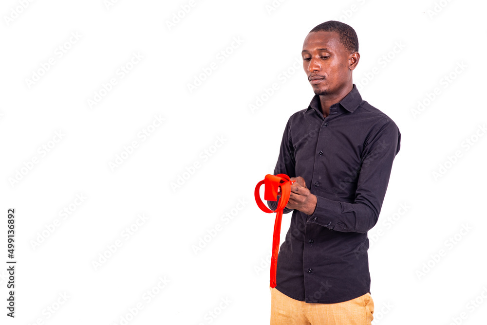 young businessman ties his red tie. young businessman ties his red tie.